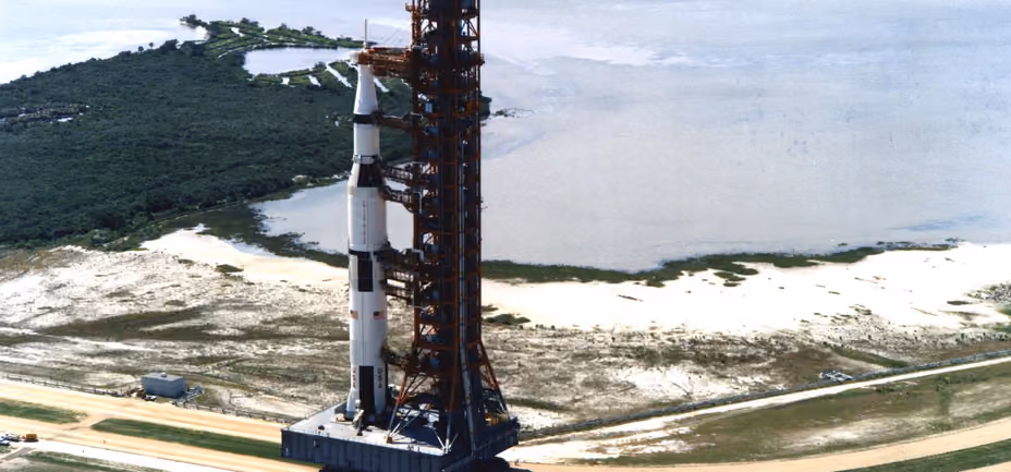 Crawler carrying the Apollo 11 Saturn V and its tower along the road to the launch pad