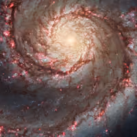 Whirlpool galaxy, a spiral with pink star-forming regions along its arms