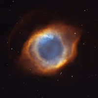 Helix Nebula, a ring of orange and blue gas around a dying star, like an eye