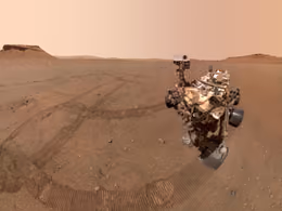 Perseverance rover selfie on a flat Martian plain, with sample tubes left on the ground