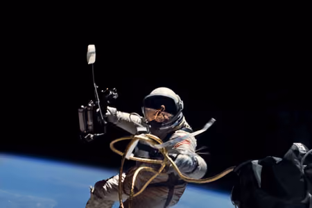 Ed White floating on a tether above Earth during the first American spacewalk