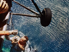 Alan Shepard lifted by a helicopter from the ocean after his flight