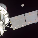 Orion's solar array between Earth and the Moon, seen from a camera on its tip