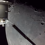 Grey cratered surface of the Moon filling the view beside the Orion spacecraft