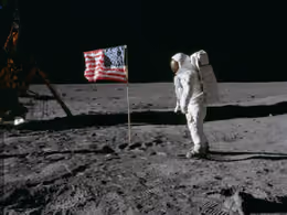 Buzz Aldrin standing beside the U.S. flag on the Moon