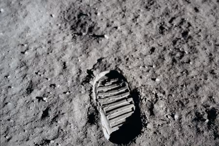 Astronaut's bootprint pressed into the grey dust of the Moon