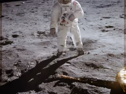 Buzz Aldrin walking on the Moon near a leg of the lunar module