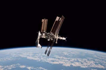 The space station with the space shuttle Endeavour docked to it, above the curve of Earth