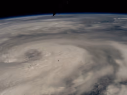 Spiral of clouds of Hurricane Helene over the sea, seen from orbit