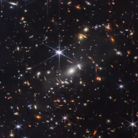 Thousands of galaxies of many shapes and colors around the galaxy cluster SMACS 0723